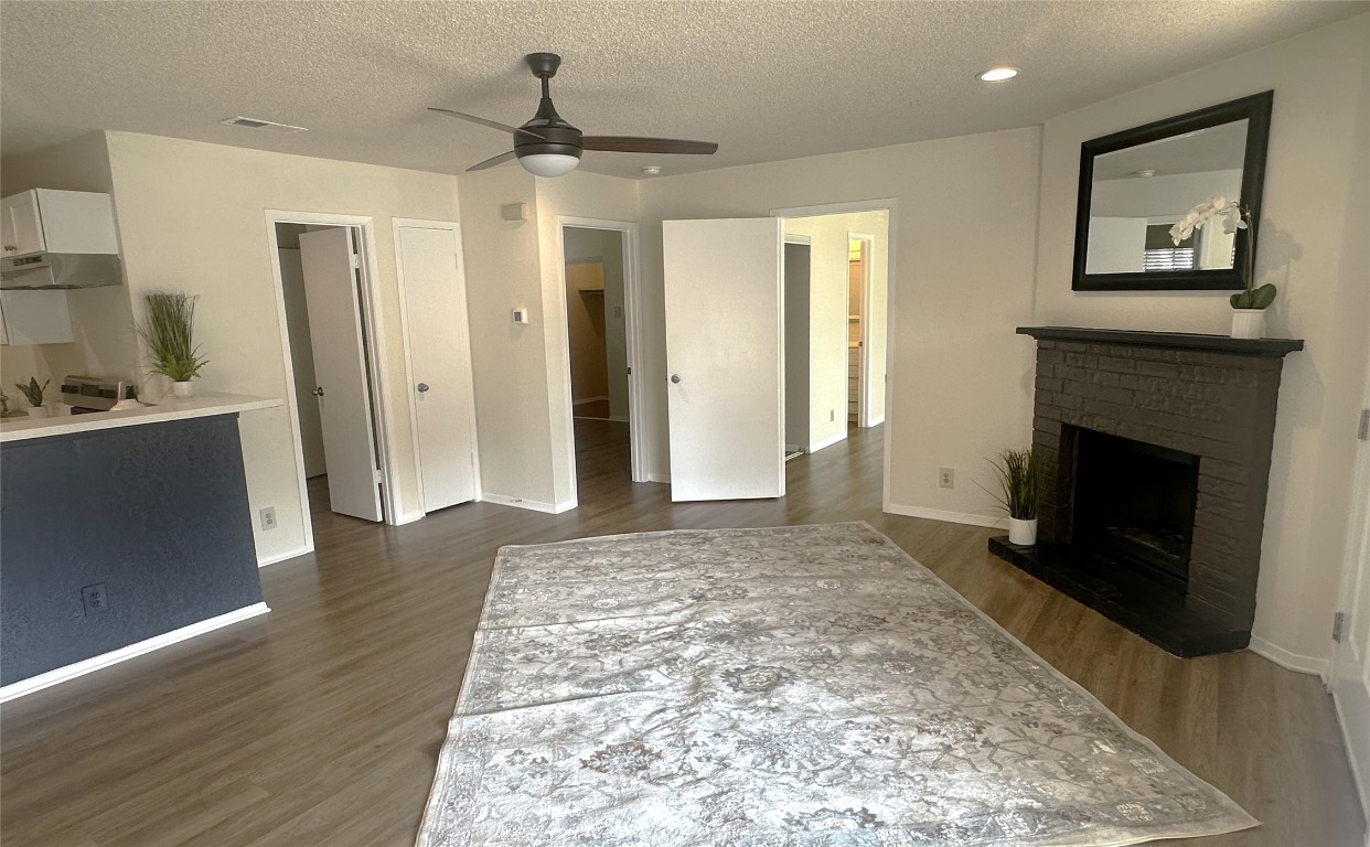 503 Algerita Drive, Unit B Georgetown, TX 78628 - Photo 5 of 30 a view of a livingroom with wooden floor and a fireplace