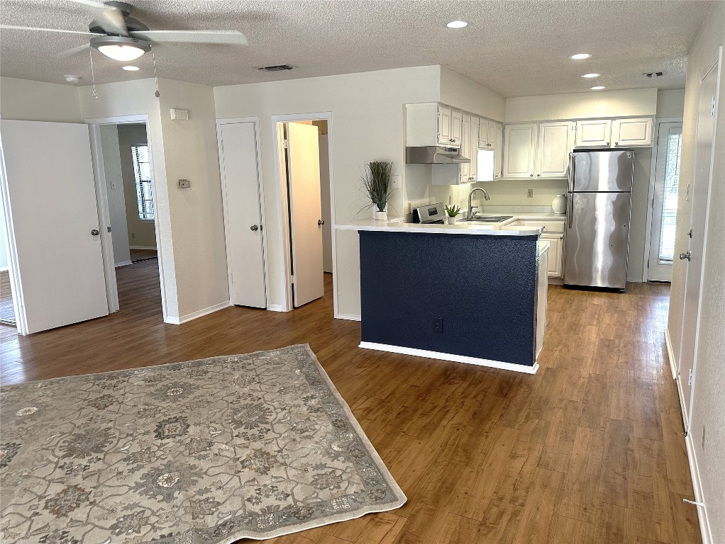 503 Algerita Drive, Unit B Georgetown, TX 78628 - Photo 7 of 30 a view of kitchen with refrigerator microwave and wooden floor