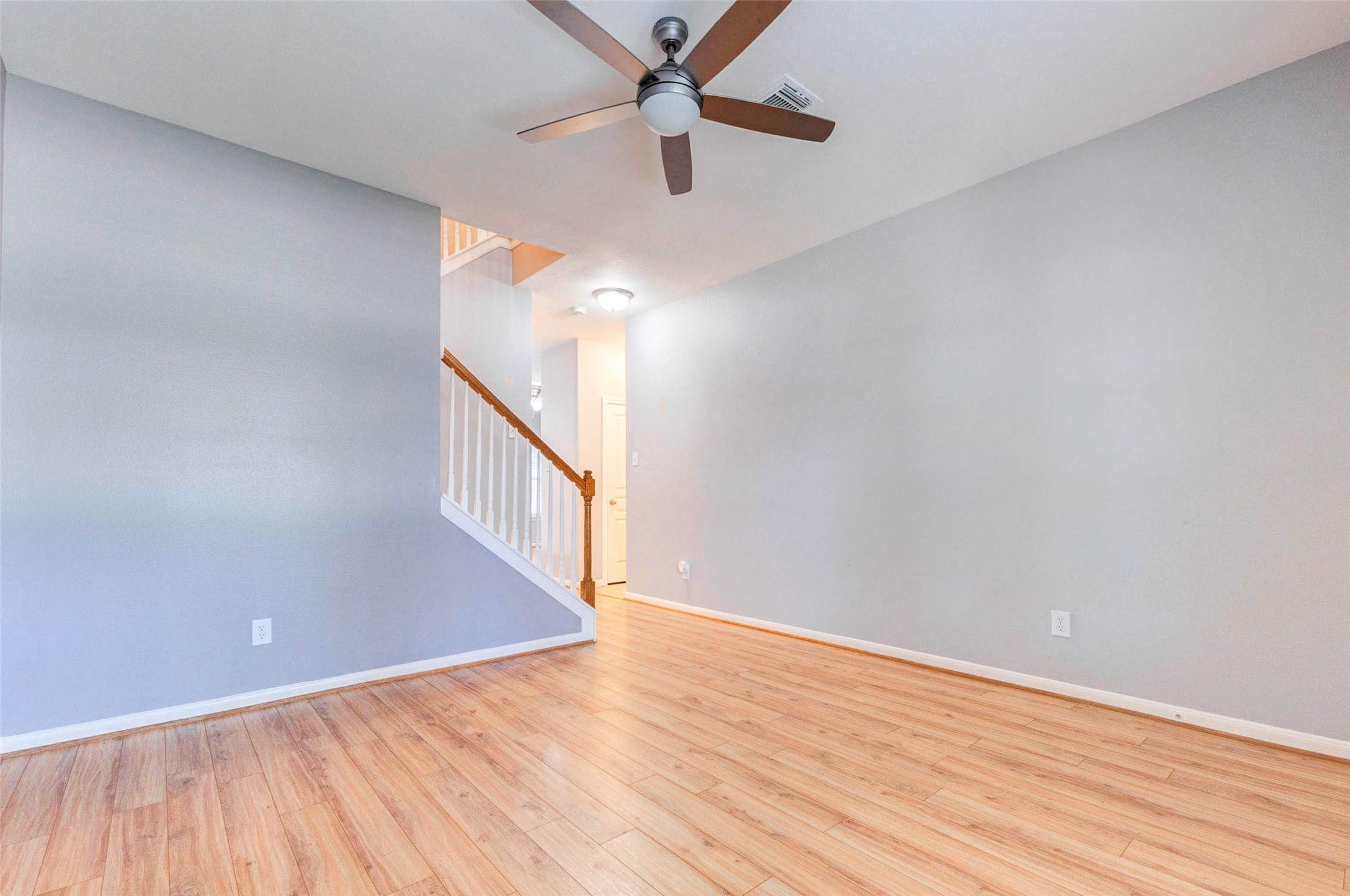 14522 Durham Chase Lane Houston, TX 77095 - Photo 4 of 40 a view of an empty room with wooden floor and a ceiling fan