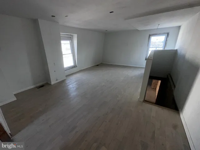a view of a livingroom with wooden floor and window