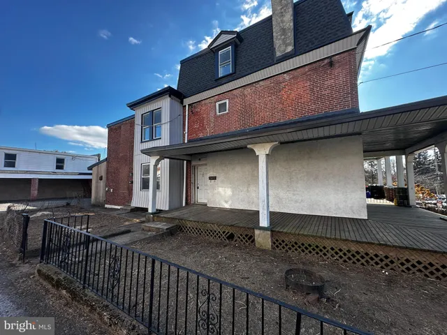 a view of a house with a wooden fence