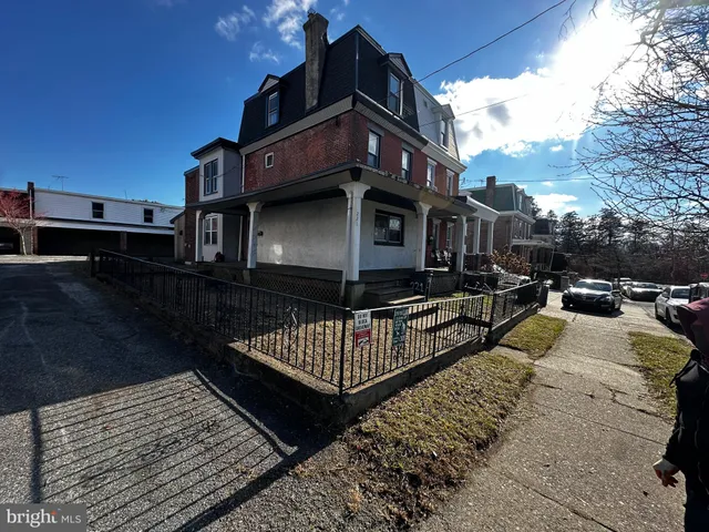 a view of a roof deck with couches and wooden floor
