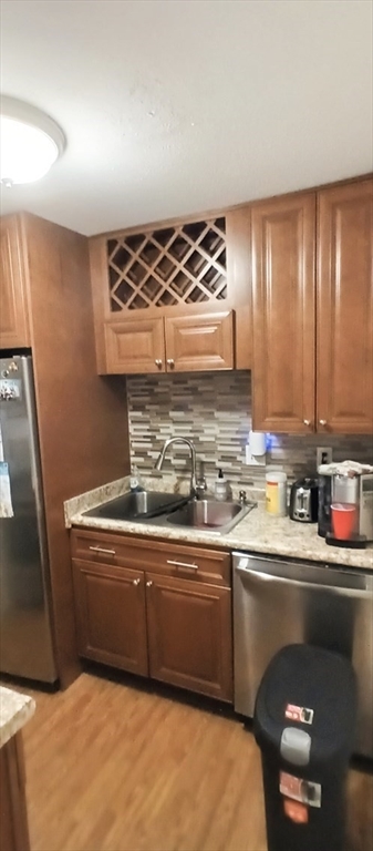 a kitchen with stainless steel appliances a sink and a stove