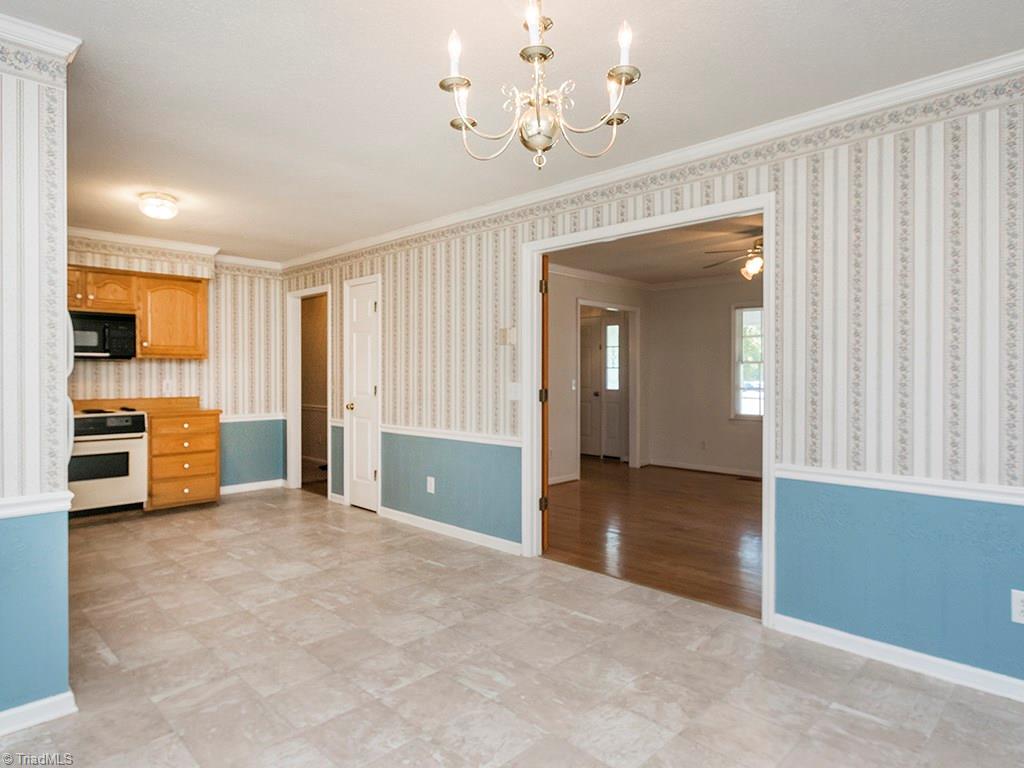 910 Trollinger Road Graham, NC 27253 - Photo 13 of 28 Large kitchen has pantry storage and a spacious eat-in area