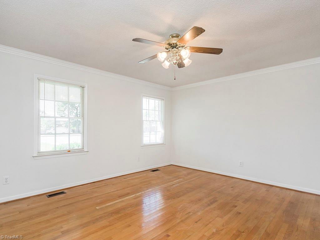 910 Trollinger Road Graham, NC 27253 - Photo 6 of 28 Spacious Living Room with Ceiling Fan and Hardwood Floors
