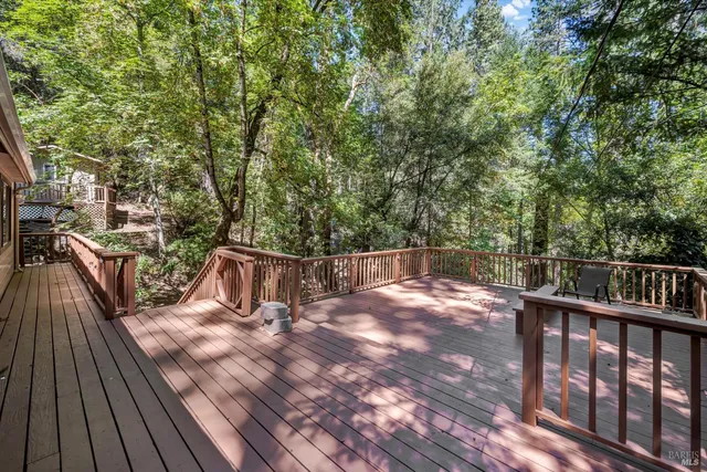 a view of balcony with wooden floor and fence