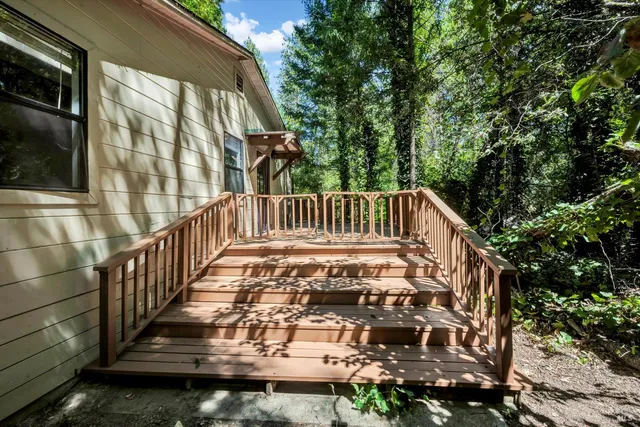 a view of a house with backyard and deck