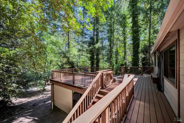 a view of a roof deck with wooden floor and fence