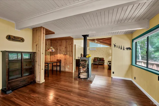 a view of a large room with wooden floor and windows