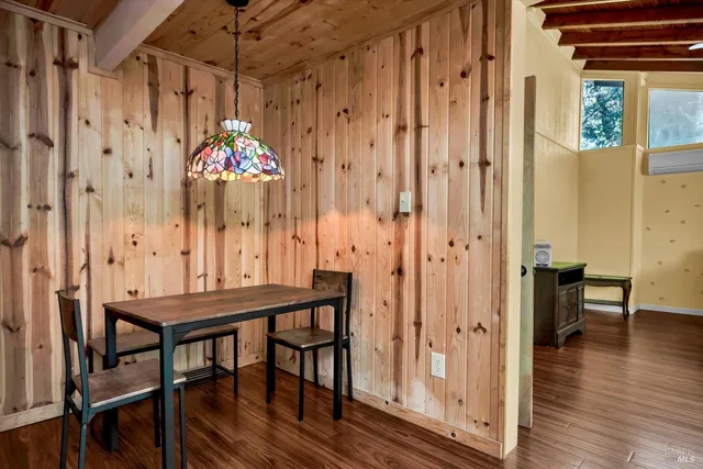 a dining room with furniture and wooden floor