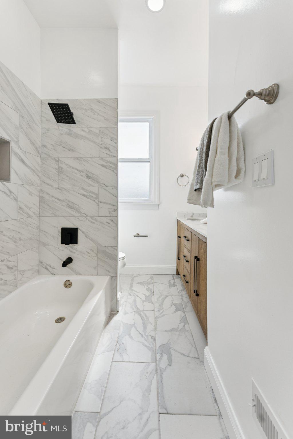2105 4th Street Northeast Washington, DC 20002 - Photo 23 of 30 a bathroom with a bathtub sink and mirror