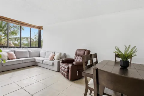 a living room with furniture potted plant and a window
