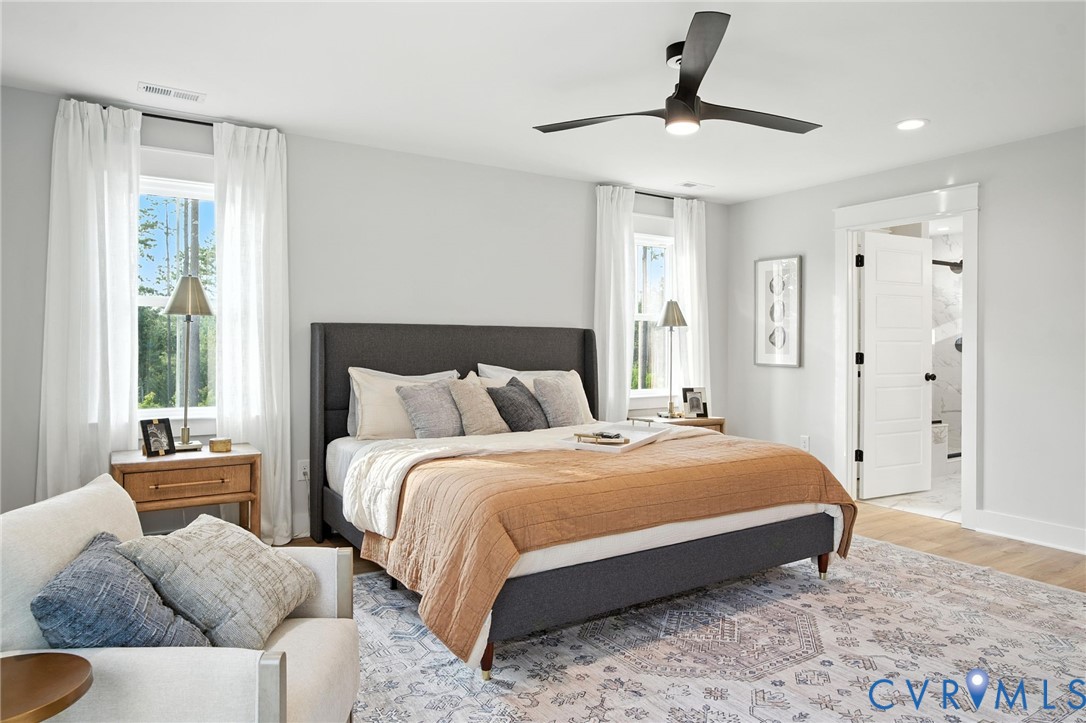 2 Winding Acres Lane New Kent, VA 23124 - Photo 20 of 31 a bedroom with a bed and a chandelier