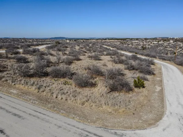 a view of a dry yard with wooden floor