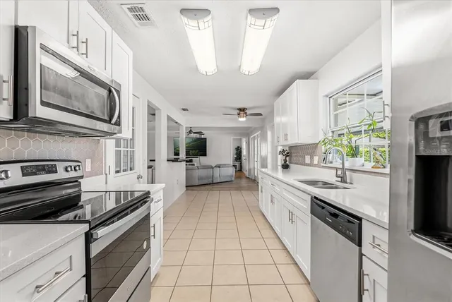 a kitchen with stainless steel appliances granite countertop a refrigerator and a sink