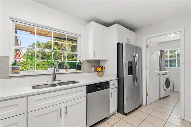 a kitchen with a stove a sink and a refrigerator