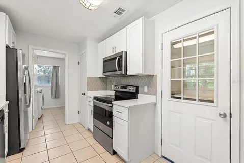 a kitchen with a stove a sink and a refrigerator