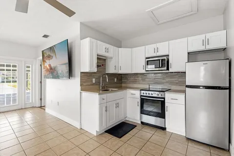 a kitchen with stainless steel appliances granite countertop a refrigerator sink and stove
