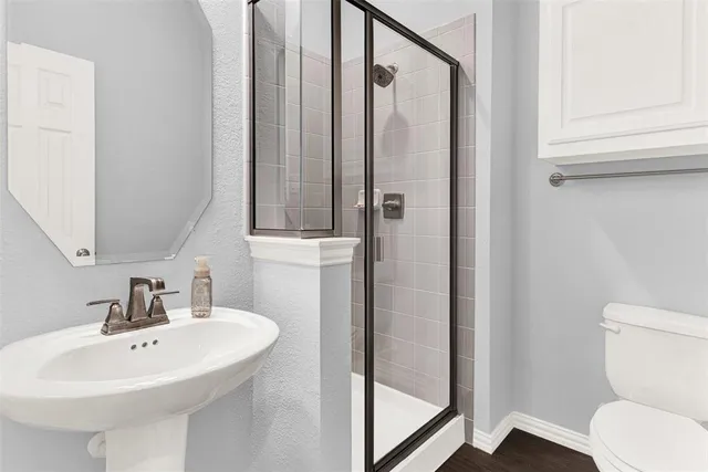 a bathroom with a sink a toilet and a mirror