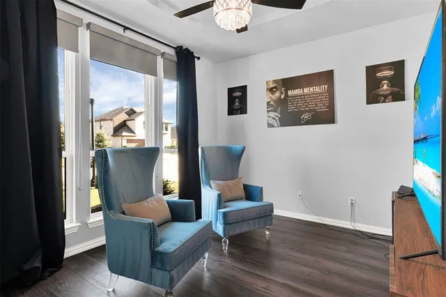 a living room with furniture and a painting on the wall