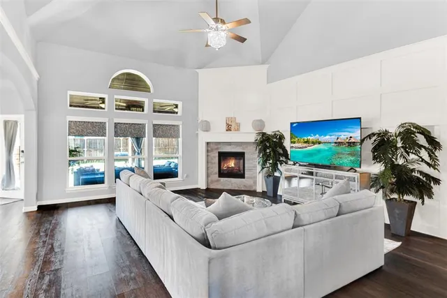 a living room with furniture fireplace and flat screen tv
