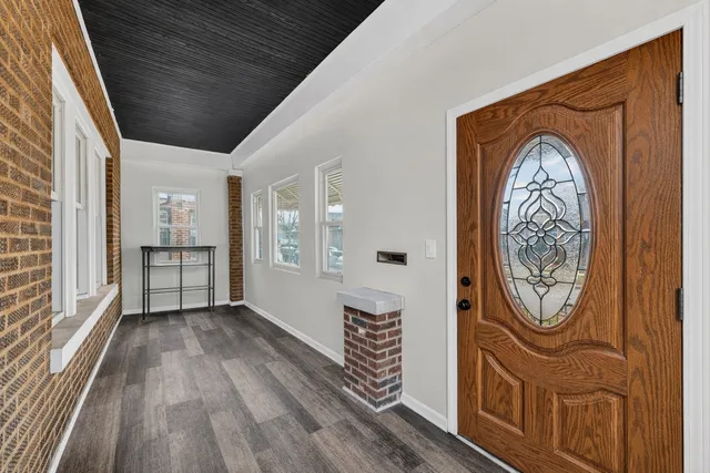 a view of an entryway with wooden floor