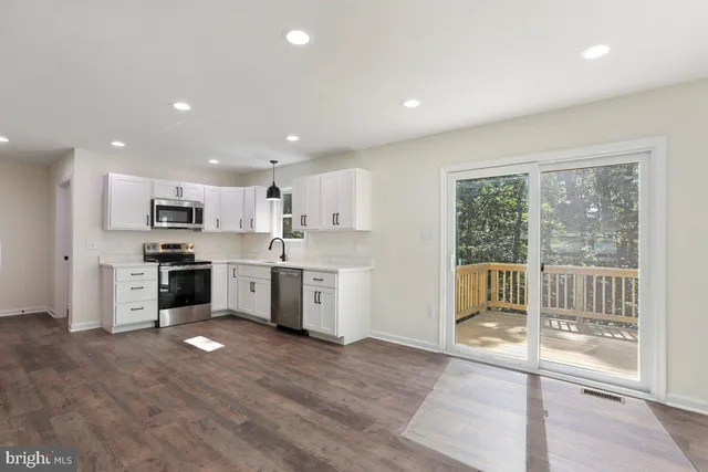a kitchen with a sink stainless steel appliances and cabinets
