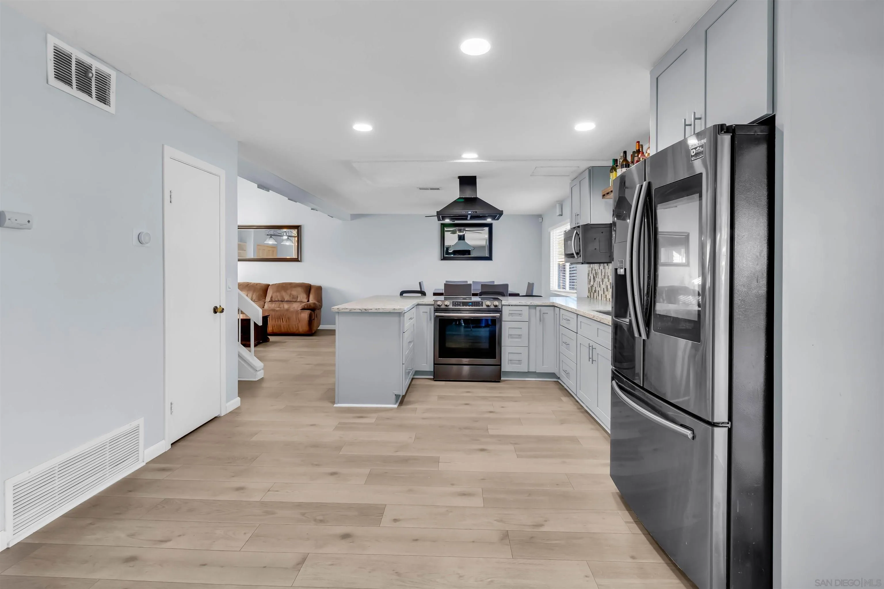 341 Paraiso Avenue Spring Valley, CA 91977 - Photo 12 of 35 a kitchen with stainless steel appliances granite countertop a refrigerator sink and stove
