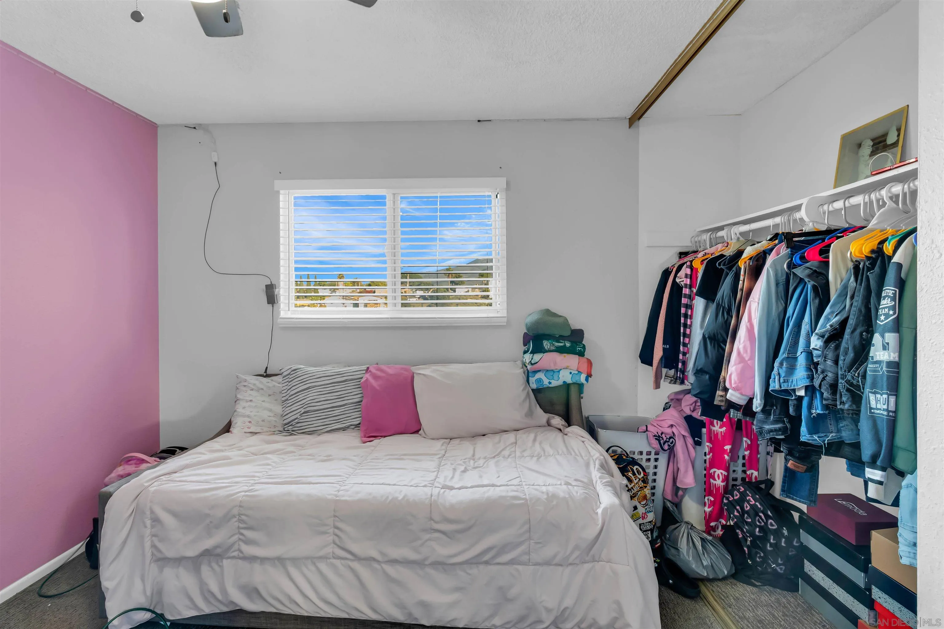 341 Paraiso Avenue Spring Valley, CA 91977 - Photo 16 of 35 a bedroom with a bed and a window