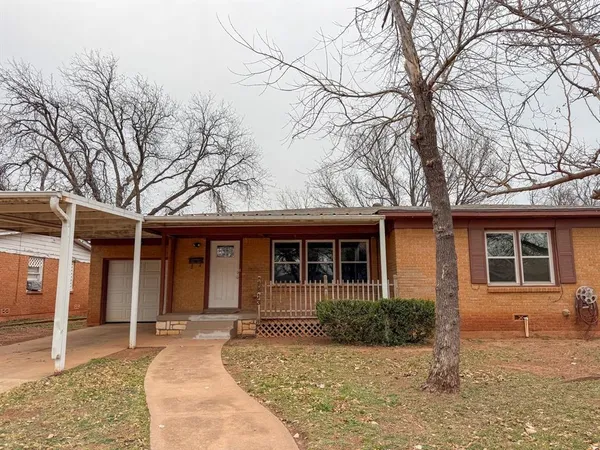 a front view of a house with yard and seating space