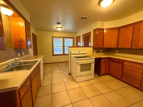 a kitchen with stainless steel appliances granite countertop a sink and cabinets