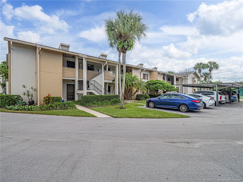 3001 Southeast Aster Lane, Unit 908 Stuart, FL 34994 - Photo 1 of 35 a view of a parked cars in front of a house