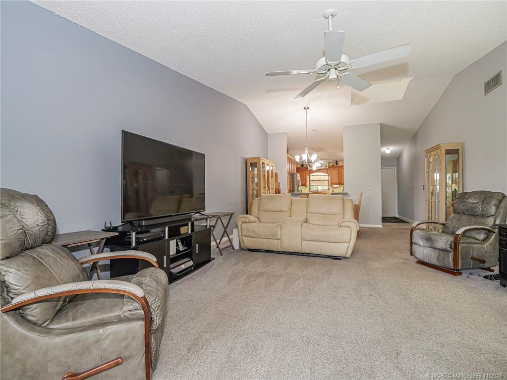 3001 Southeast Aster Lane, Unit 908 Stuart, FL 34994 - Photo 14 of 35 a living room with furniture and a flat screen tv