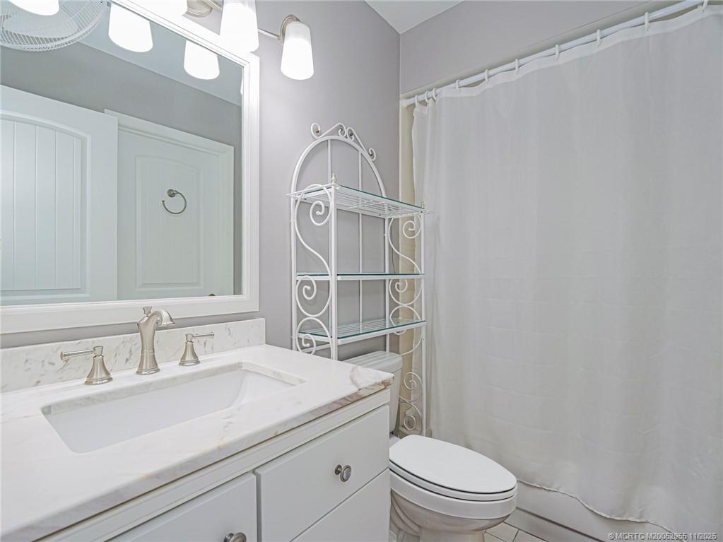 3001 Southeast Aster Lane, Unit 908 Stuart, FL 34994 - Photo 20 of 35 a bathroom with a sink a toilet and shower
