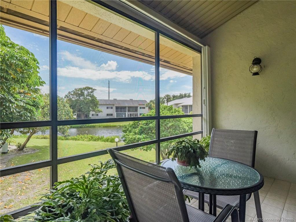 3001 Southeast Aster Lane, Unit 908 Stuart, FL 34994 - Photo 22 of 35 a view of a porch with furniture and garden