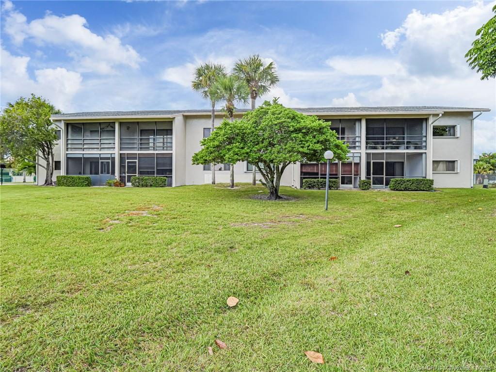 3001 Southeast Aster Lane, Unit 908 Stuart, FL 34994 - Photo 25 of 35 a view of a house with a yard and sitting area