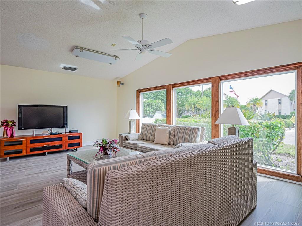 3001 Southeast Aster Lane, Unit 908 Stuart, FL 34994 - Photo 31 of 35 a living room with furniture and a flat screen tv
