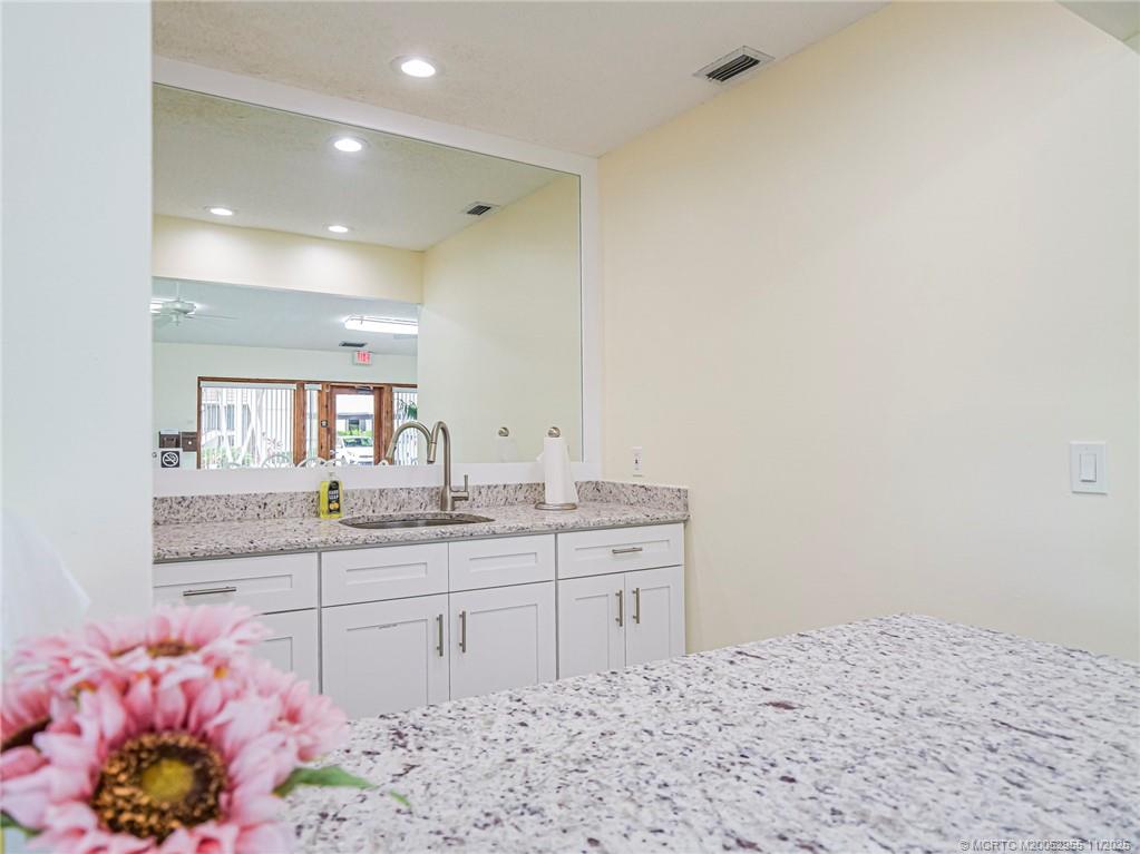 3001 Southeast Aster Lane, Unit 908 Stuart, FL 34994 - Photo 32 of 35 a bathroom with a sink and a mirror