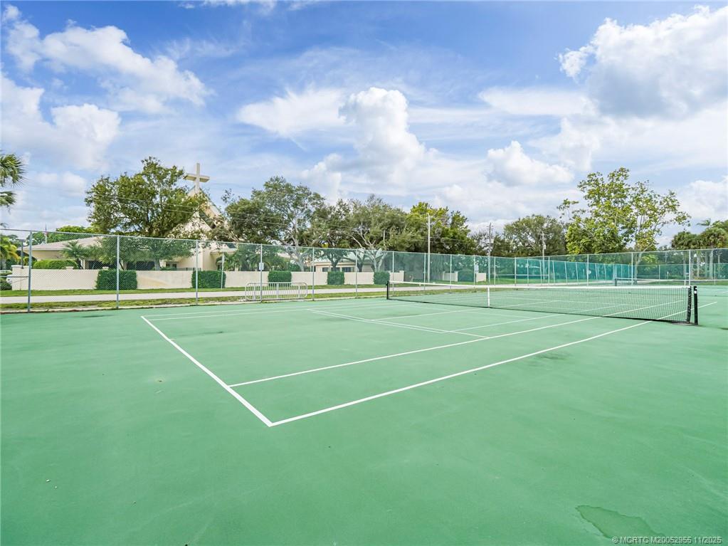 3001 Southeast Aster Lane, Unit 908 Stuart, FL 34994 - Photo 35 of 35 a view of a tennis ground with large trees