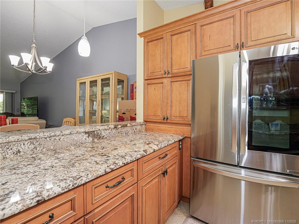 3001 Southeast Aster Lane, Unit 908 Stuart, FL 34994 - Photo 8 of 35 a kitchen with stainless steel appliances granite countertop a refrigerator and a sink