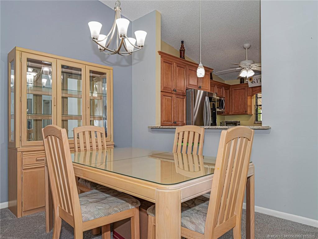3001 Southeast Aster Lane, Unit 908 Stuart, FL 34994 - Photo 9 of 35 a dining room with furniture and window