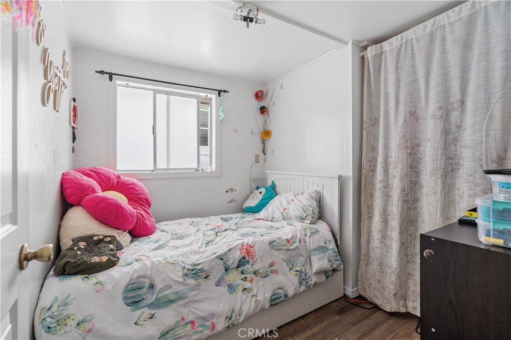 343 Eucalyptus Avenue Avalon, CA 90704 - Photo 12 of 35 a bedroom with a bed and a window