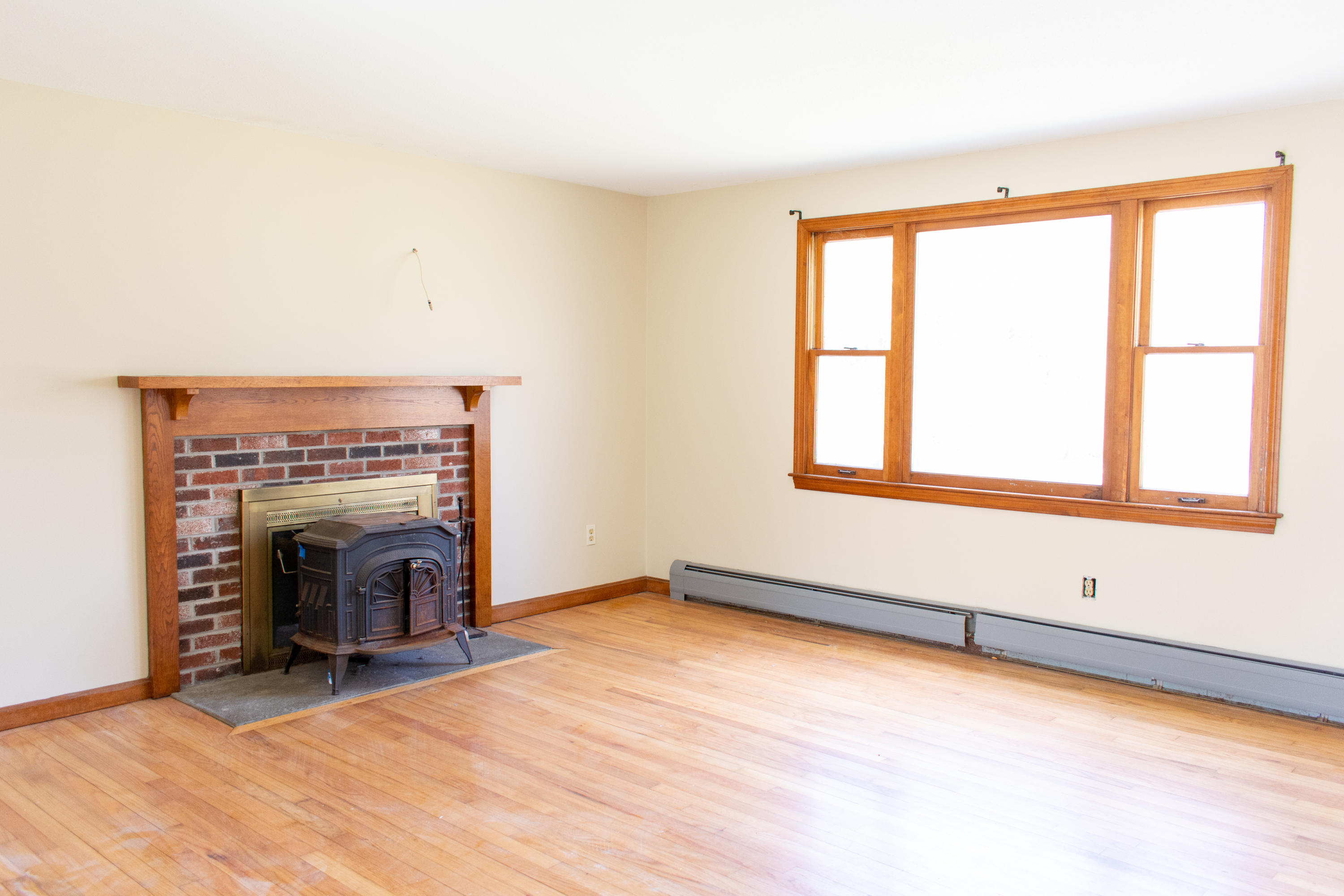 398 Lincoln Rd Extension Hyannis, MA 02601 - Photo 4 of 26 an empty room with fireplace and windows