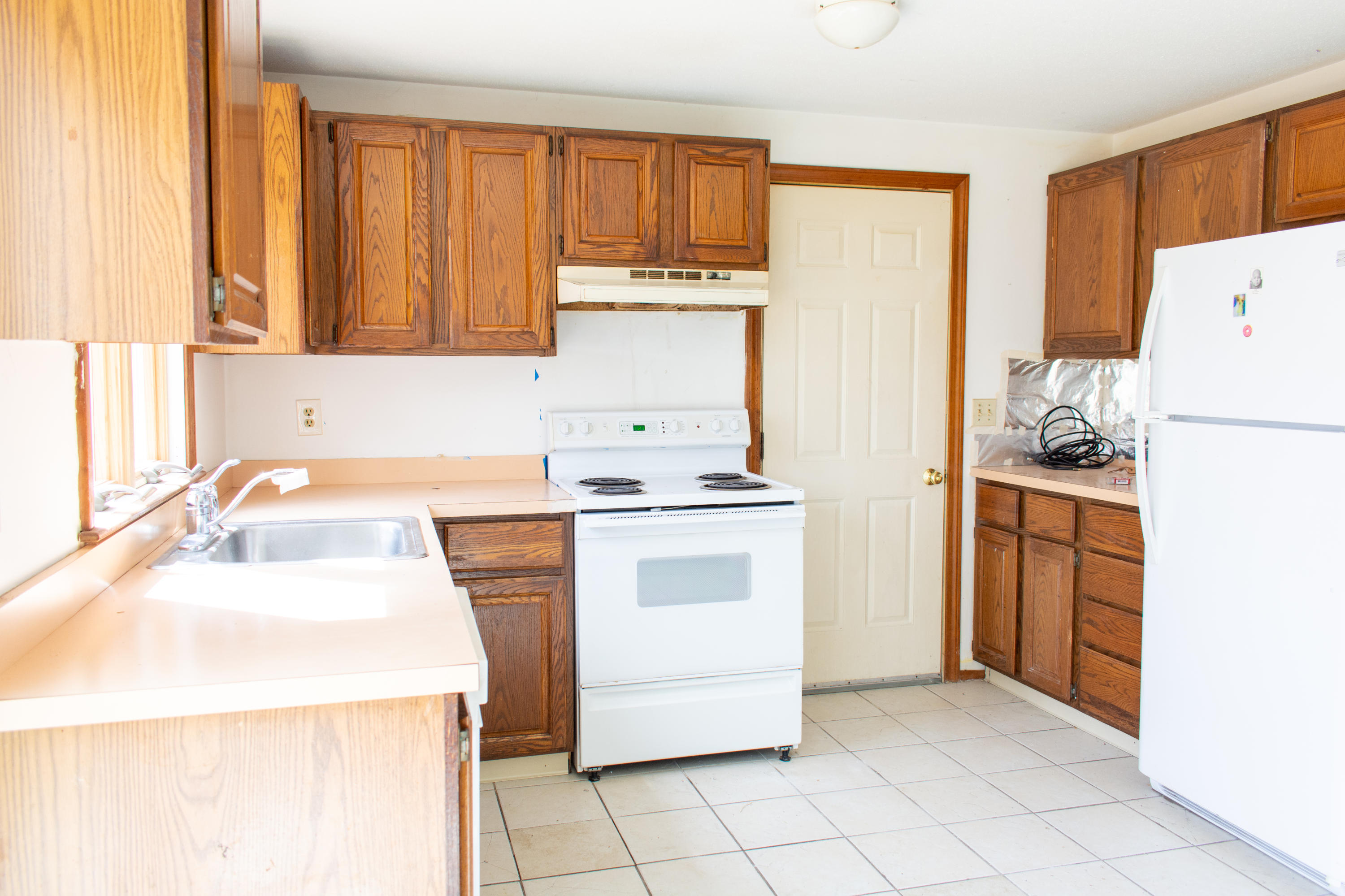 398 Lincoln Rd Extension Hyannis, MA 02601 - Photo 8 of 26 a kitchen with a sink a stove a refrigerator and a window