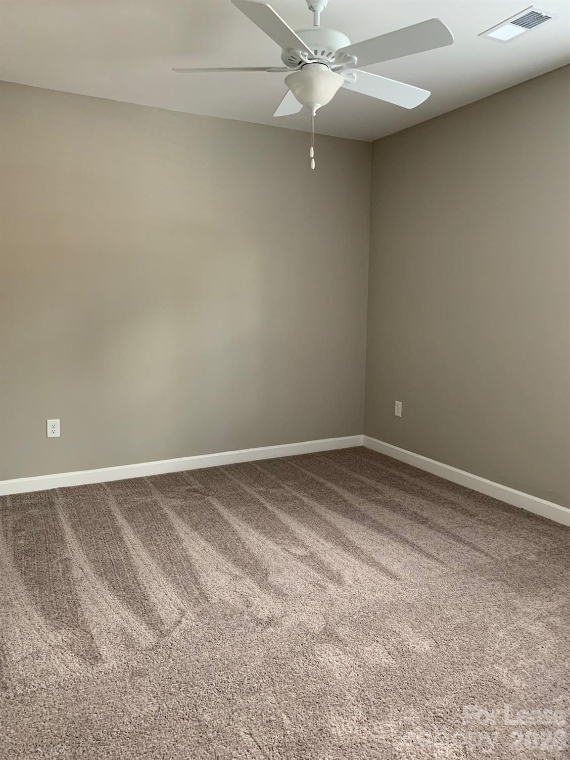 50 Riverside Drive Hickory, NC 28601 - Photo 11 of 16 en empty room with windows and fan