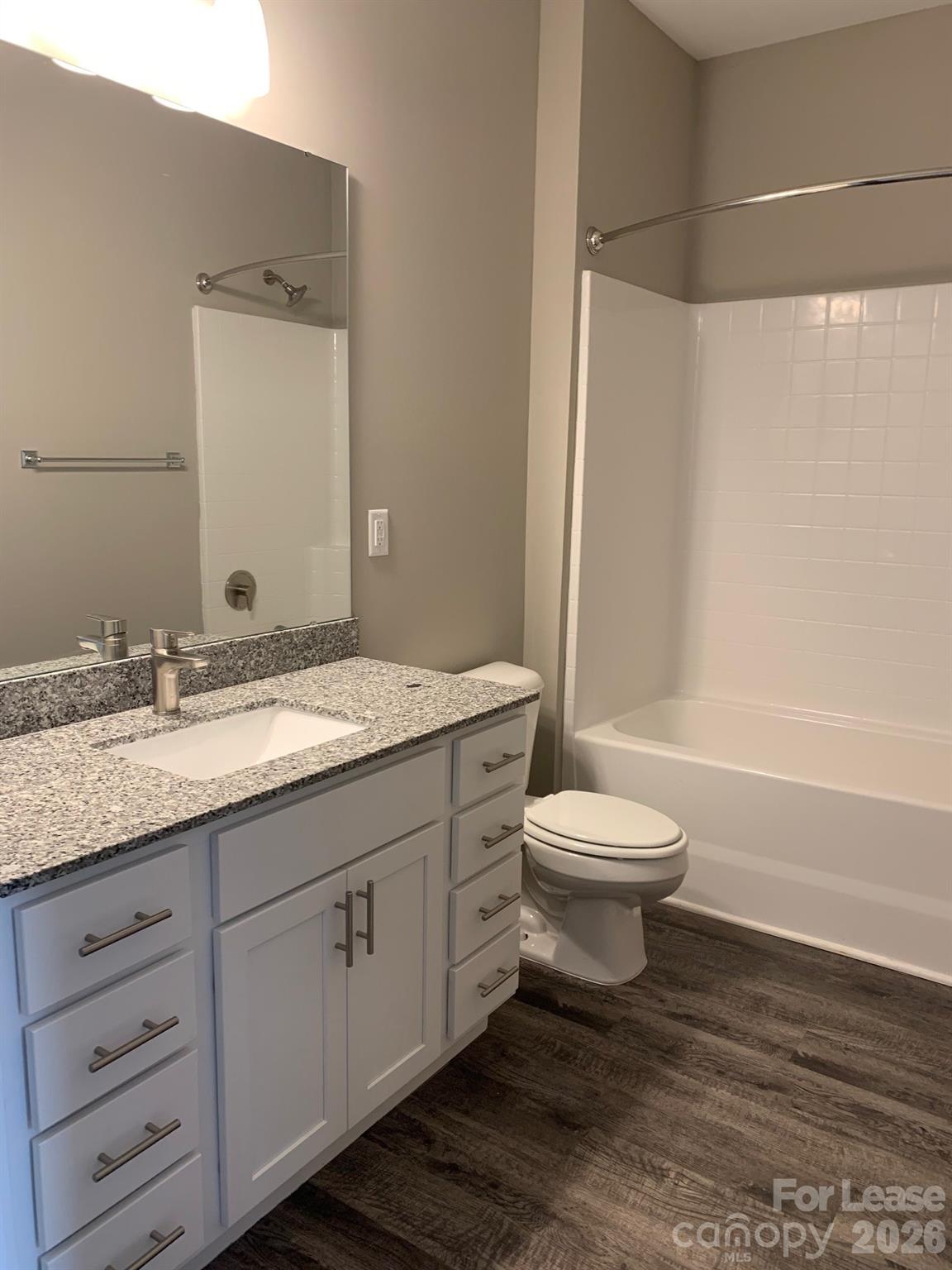 50 Riverside Drive Hickory, NC 28601 - Photo 12 of 16 a bathroom with a granite countertop sink toilet a large mirror and shower