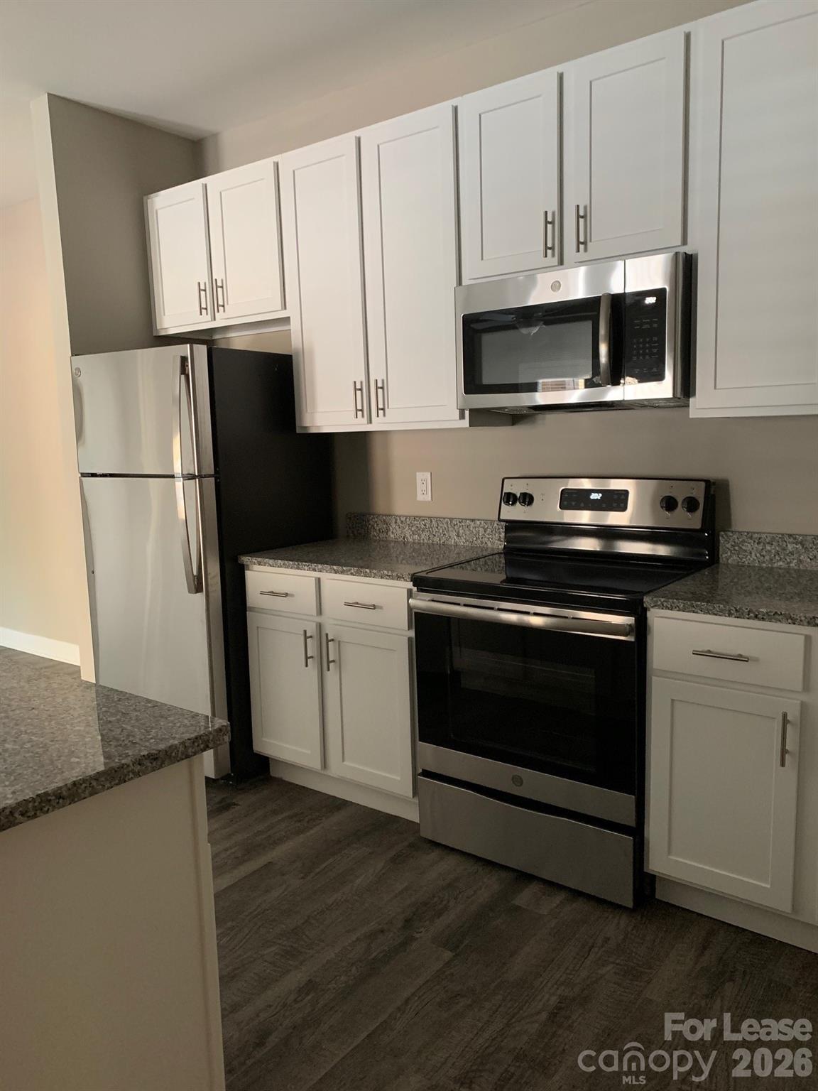 50 Riverside Drive Hickory, NC 28601 - Photo 2 of 16 a kitchen with granite countertop white cabinets and white appliances
