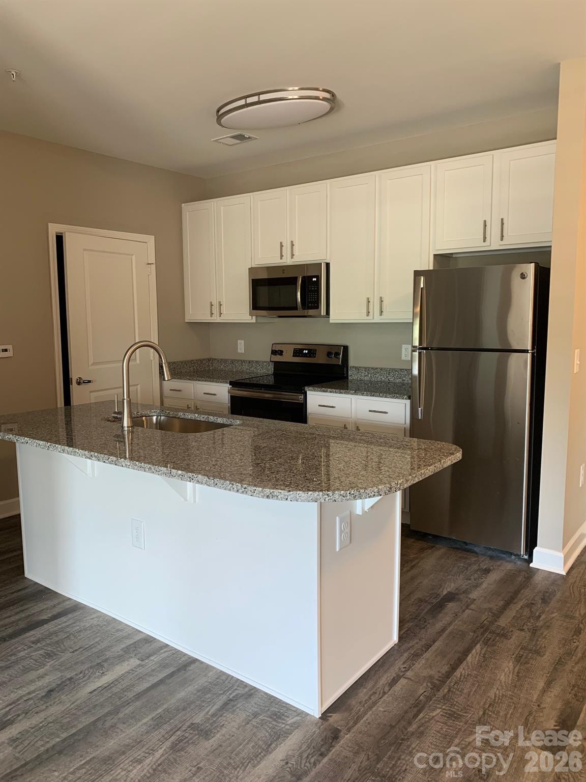 50 Riverside Drive Hickory, NC 28601 - Photo 5 of 16 a kitchen with stainless steel appliances granite countertop a sink a refrigerator a stove a microwave and cabinets
