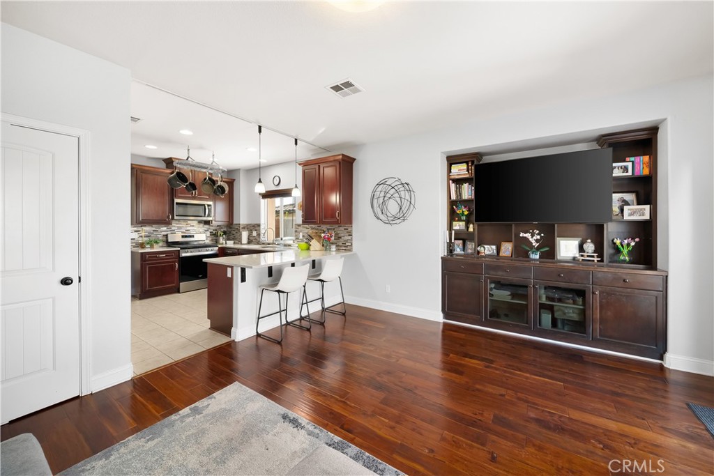 731 Voyager Road Lompoc, CA 93436 - Photo 11 of 57 a living room with stainless steel appliances kitchen island granite countertop furniture and a flat screen tv