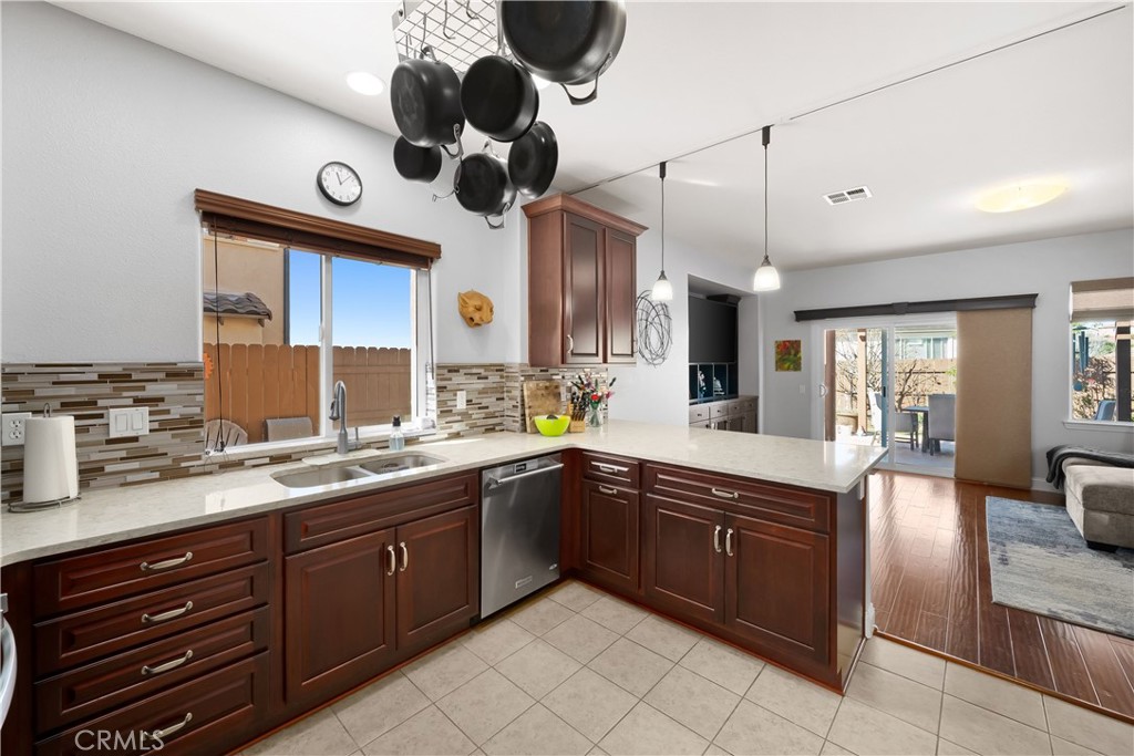 731 Voyager Road Lompoc, CA 93436 - Photo 14 of 57 a large kitchen with a large island appliances a sink cabinets and living room view